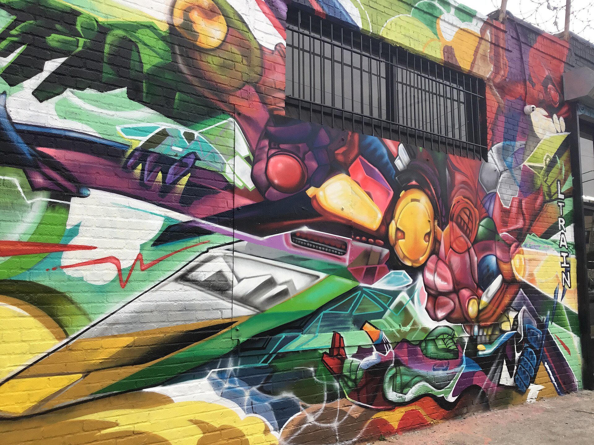 A vivid multicolored street-art mural on a warehouse wall in the Bushwick Collective, Brooklyn