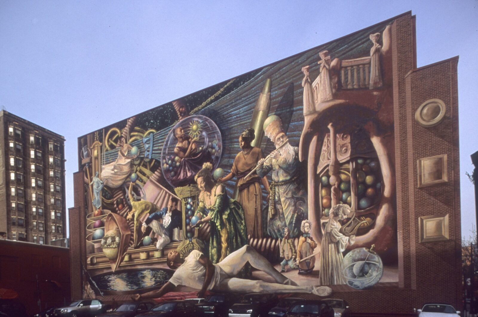Philadelphia Muses — nine muses reimagined as contemporary Philadelphia artists, gathered around a machine spinning out spheres, five stories tall at 13th and Locust